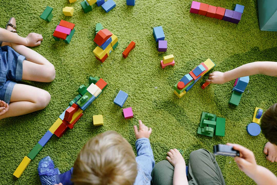 Play-based pediatric therapy session Toddlers playing with colorful building blocks during a play-based therapy session